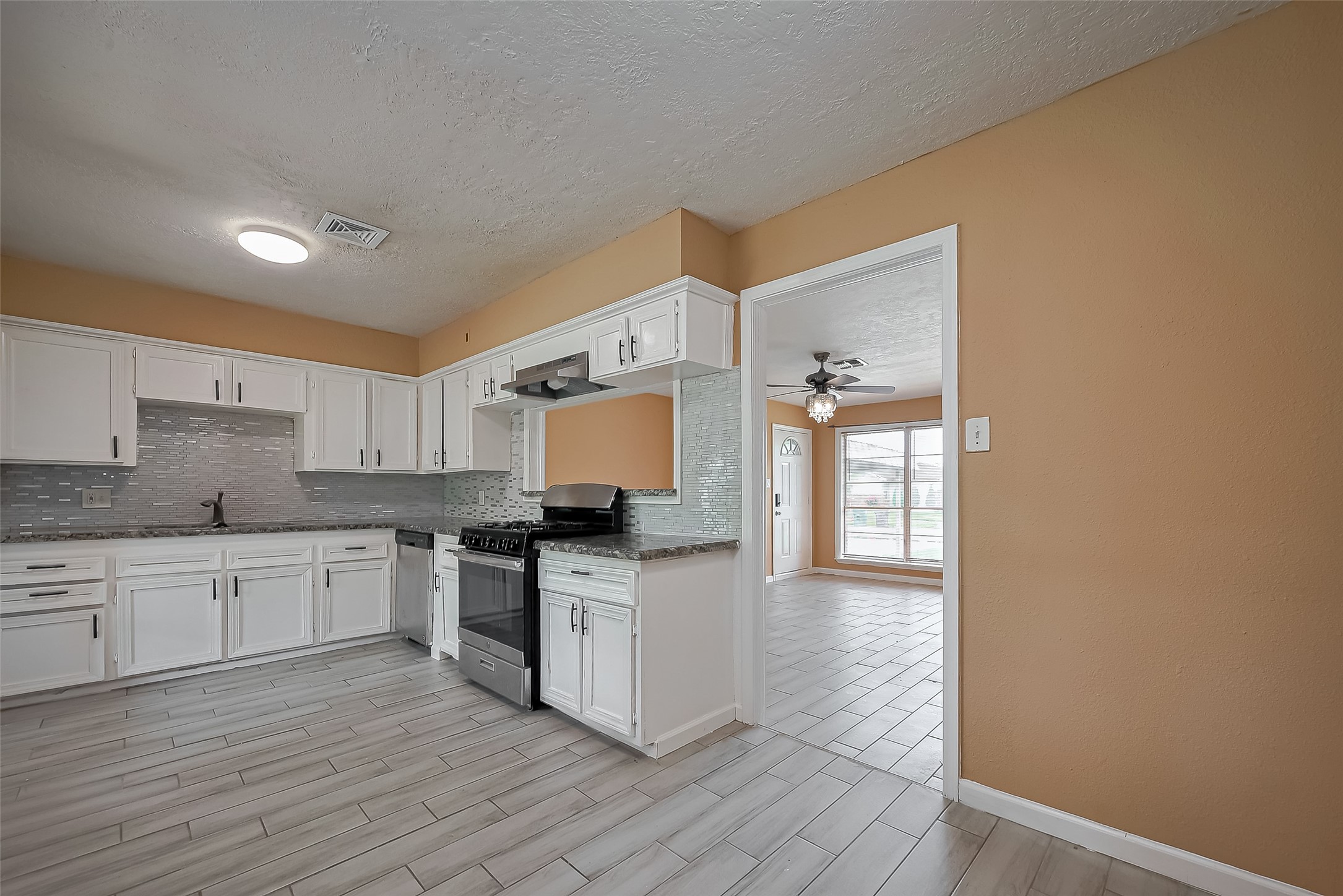 626 Shawnee Street Houston, TX 77034 - Photo 6 of 16 a kitchen with stainless steel appliances granite countertop a stove top oven a sink a counter space and cabinets