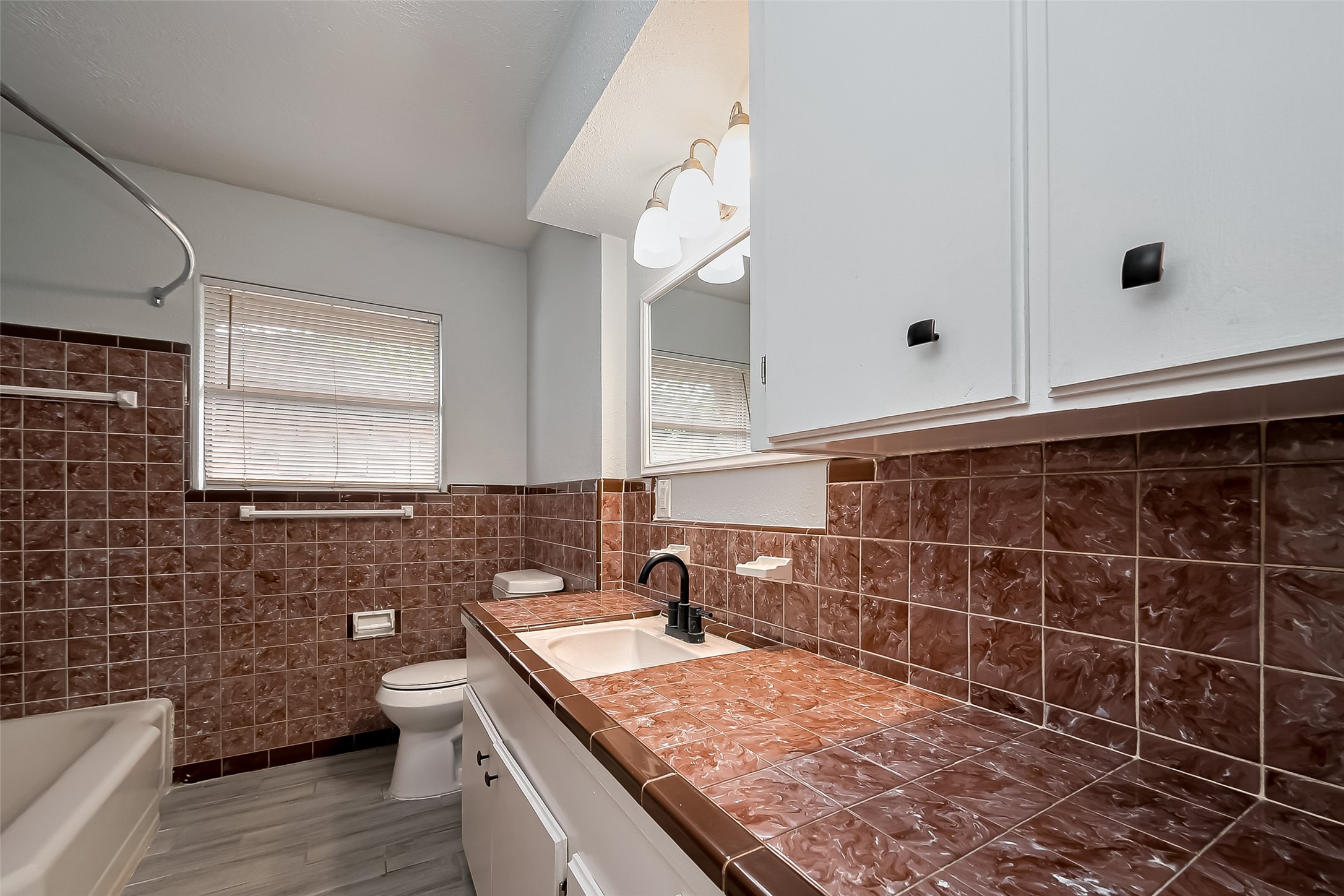626 Shawnee Street Houston, TX 77034 - Photo 8 of 16 a bathroom with a granite countertop sink a toilet and mirror