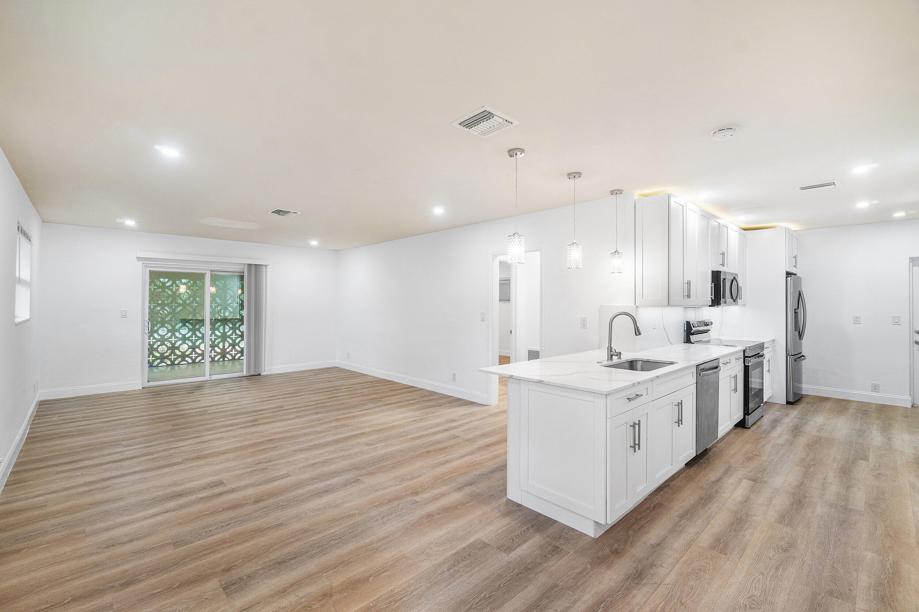 434 Southwest 9th Street, Unit A Boca Raton, FL 33432 - Photo 1 of 22 a large white kitchen with a large window a sink and a stove