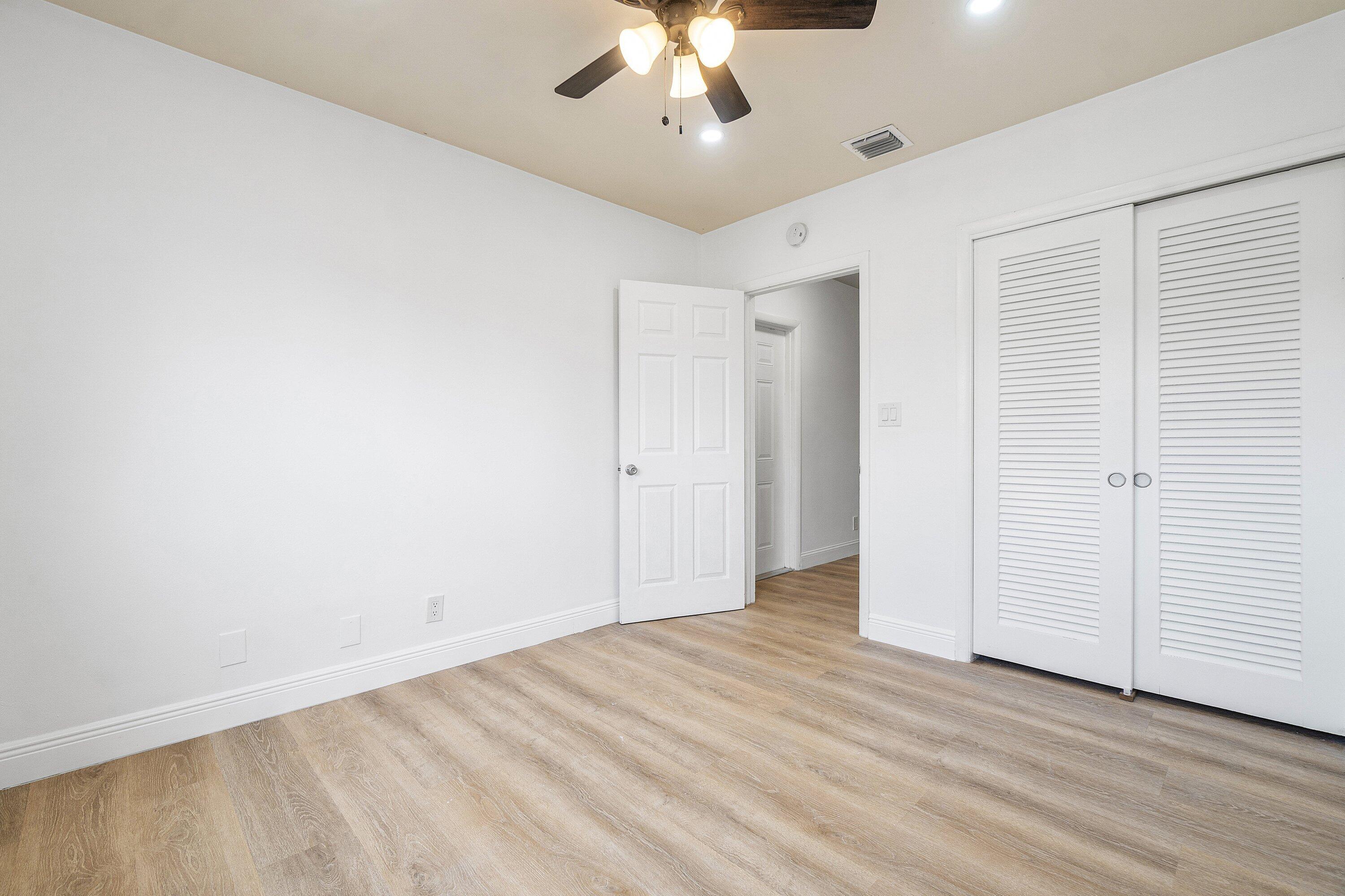 434 Southwest 9th Street, Unit A Boca Raton, FL 33432 - Photo 12 of 22 wooden floor in an empty room with a window