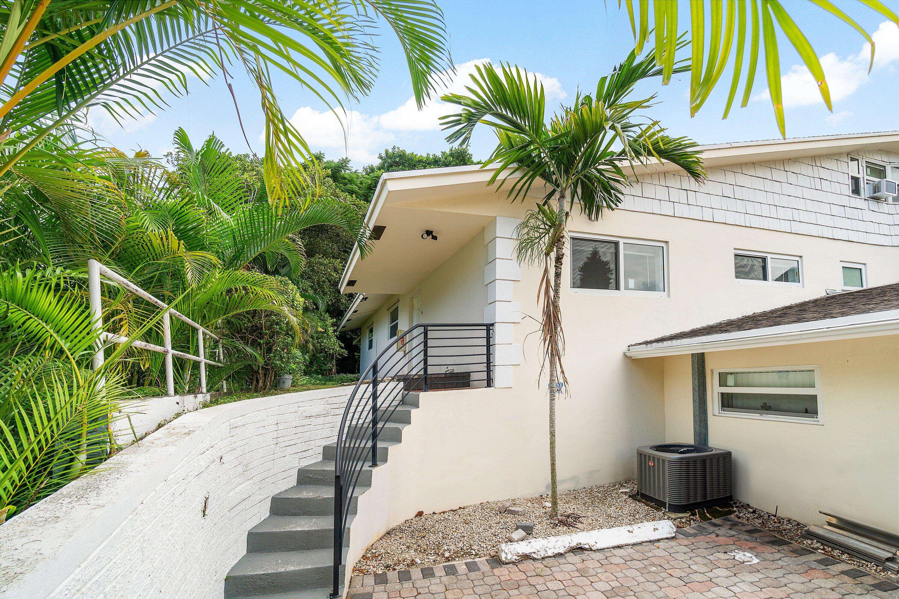 434 Southwest 9th Street, Unit A Boca Raton, FL 33432 - Photo 19 of 22 a front view of a house with garden