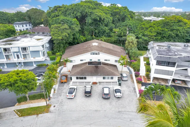 an aerial view of a swimming pool with outdoor seating and plants