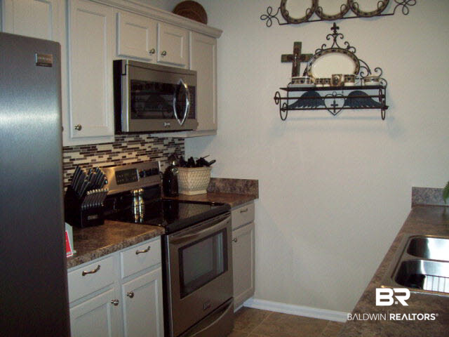 1517 Regency Road, Unit 123 Gulf Shores, AL 36542 - Photo 16 of 31 NEW 16" TILE IN KITCHEN