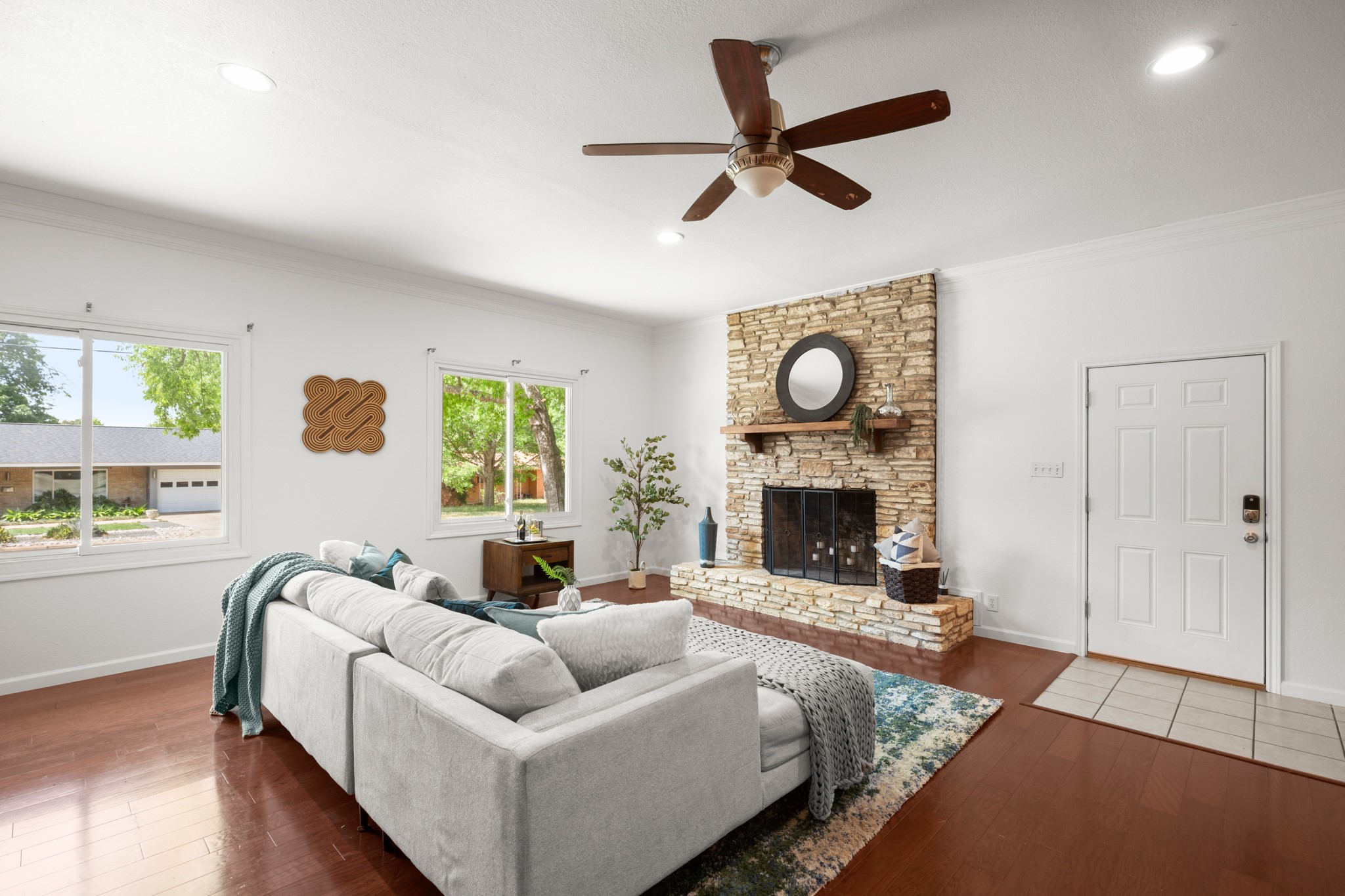 4702 Lasso Path Austin, TX 78745 - Photo 18 of 31 Living area featuring hardwood / wood-style floors, crown molding, ceiling fan, a fireplace, and recessed lighting