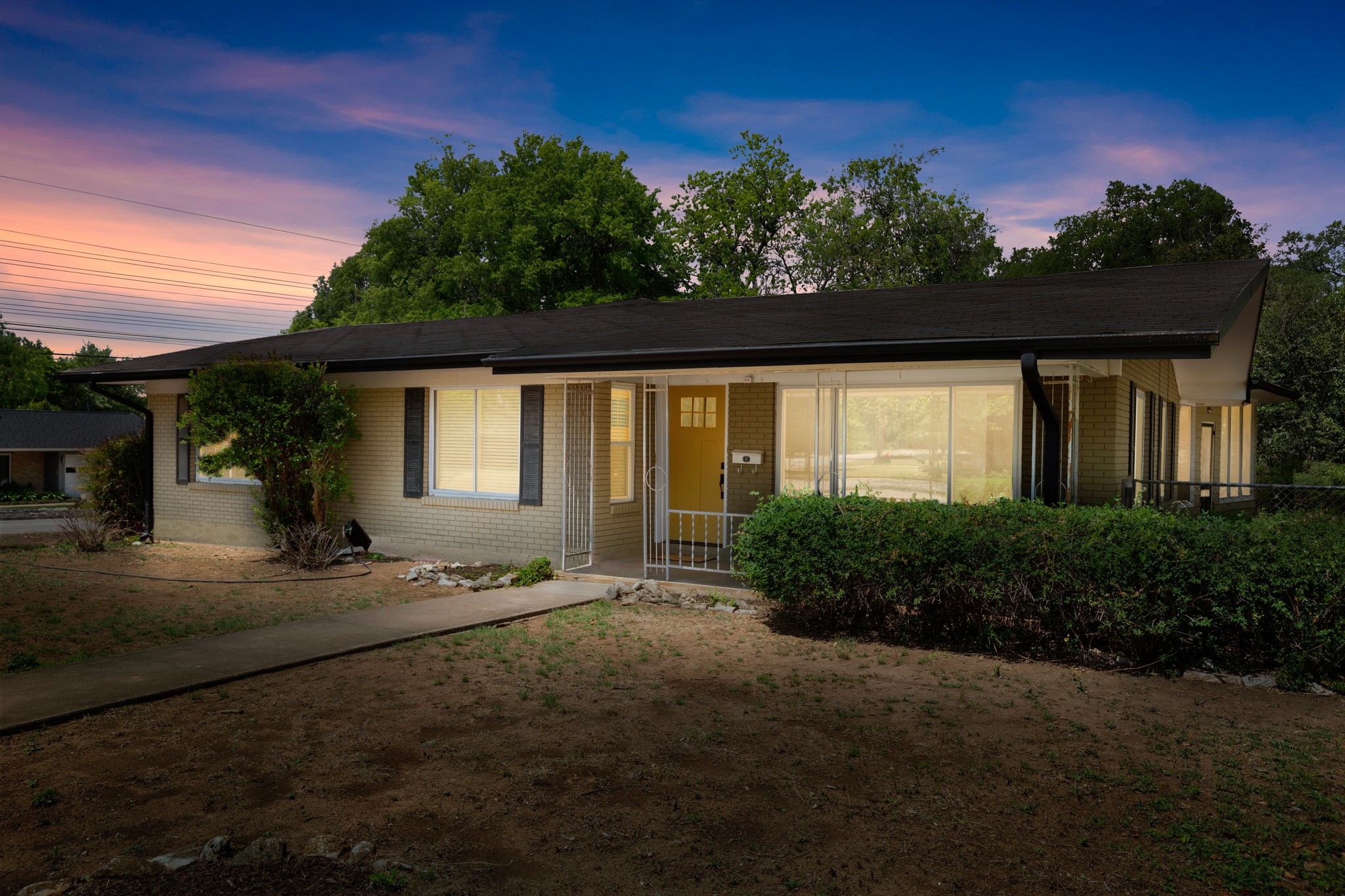 4702 Lasso Path Austin, TX 78745 - Photo 31 of 31 Single story home with covered porch, brick siding, and a yard