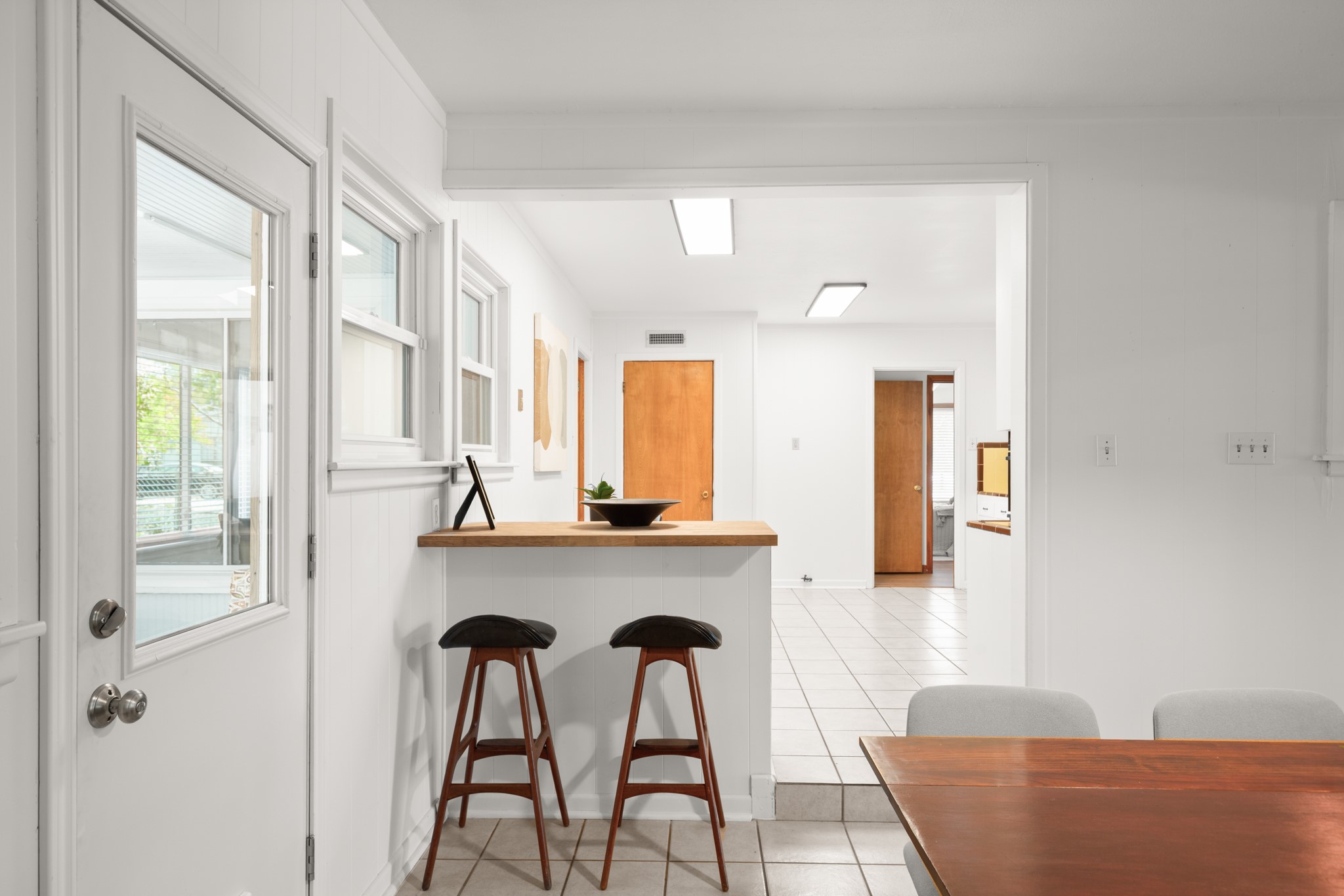 4702 Lasso Path Austin, TX 78745 - Photo 9 of 31 Kitchen featuring a kitchen breakfast bar, a peninsula, light tile patterned floors, and butcher block counters
