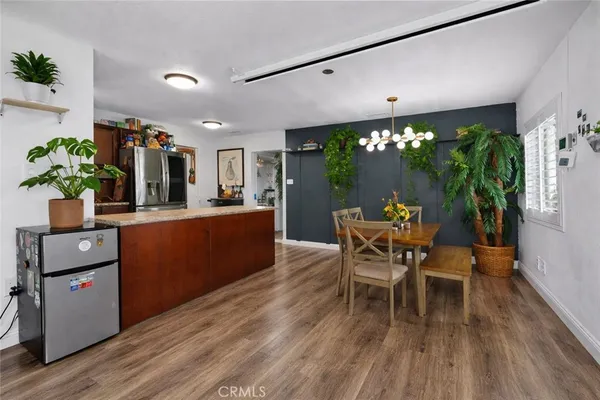 a dining room with furniture and wooden floor