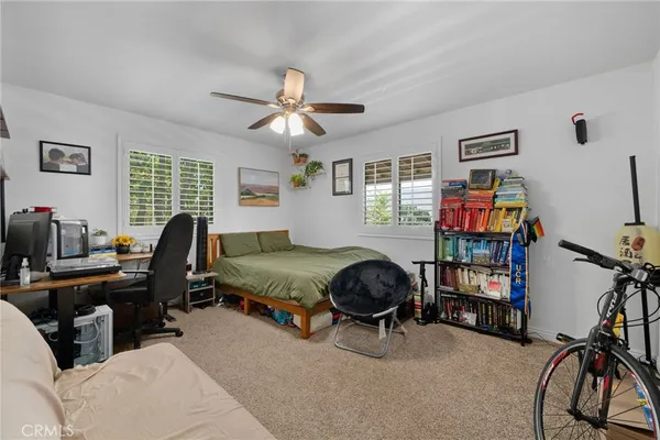 a bedroom with furniture and a window