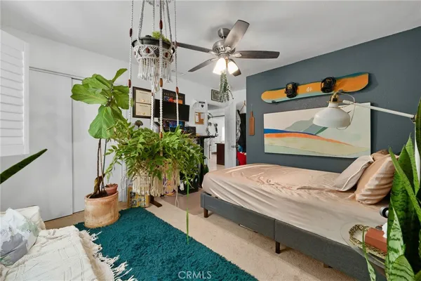 a living room with patio furniture and a chandelier