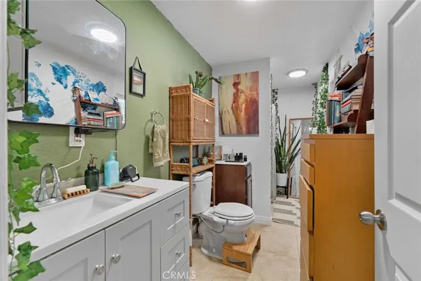 a bathroom with a sink mirror vanity and toilet