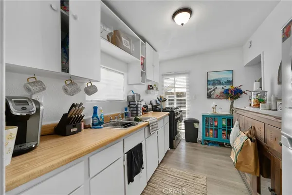 a kitchen with a sink cabinets and wooden floor
