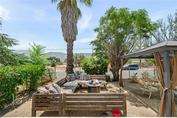 a view of a patio with table and chairs with potted plants