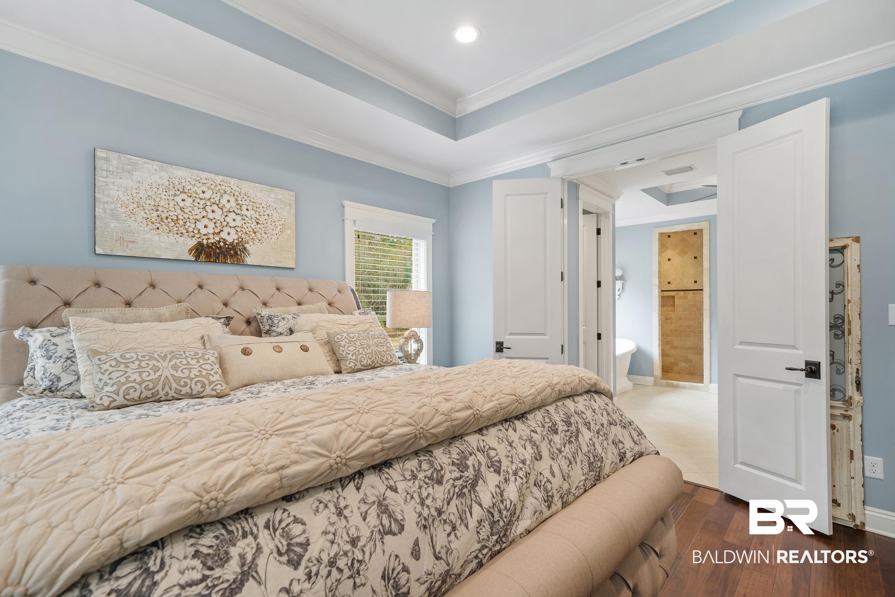 36784 Legacy Way Bay Minette, AL 36507 - Photo 21 of 57 Oversized bedroom featuring sitting area/office, crown molding, a tray ceiling, and wood-style floors