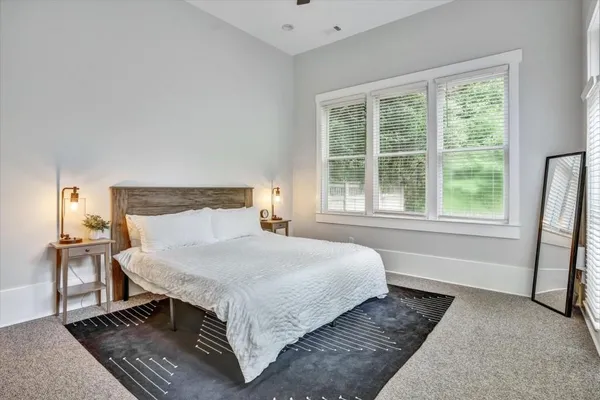 a bedroom with a large bed and a window