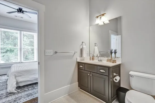 a bathroom with a toilet a sink and mirror