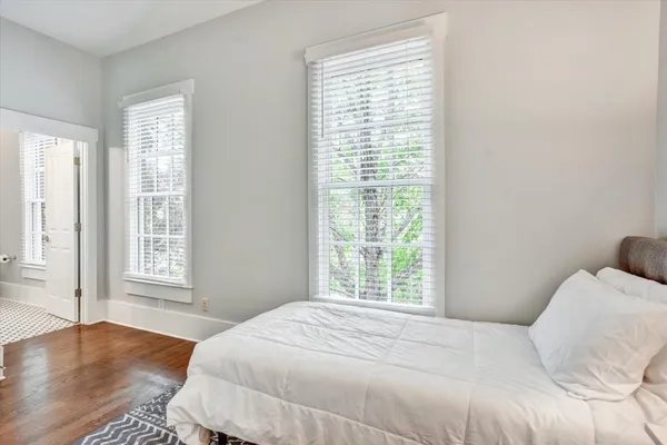 a bedroom with a bed and a window