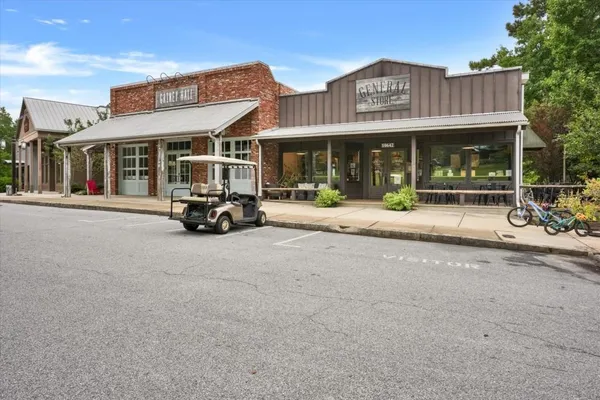 a view of a brick building with a large window and sitting area