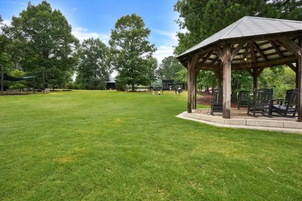 a view of a patio with a table chairs and a yard
