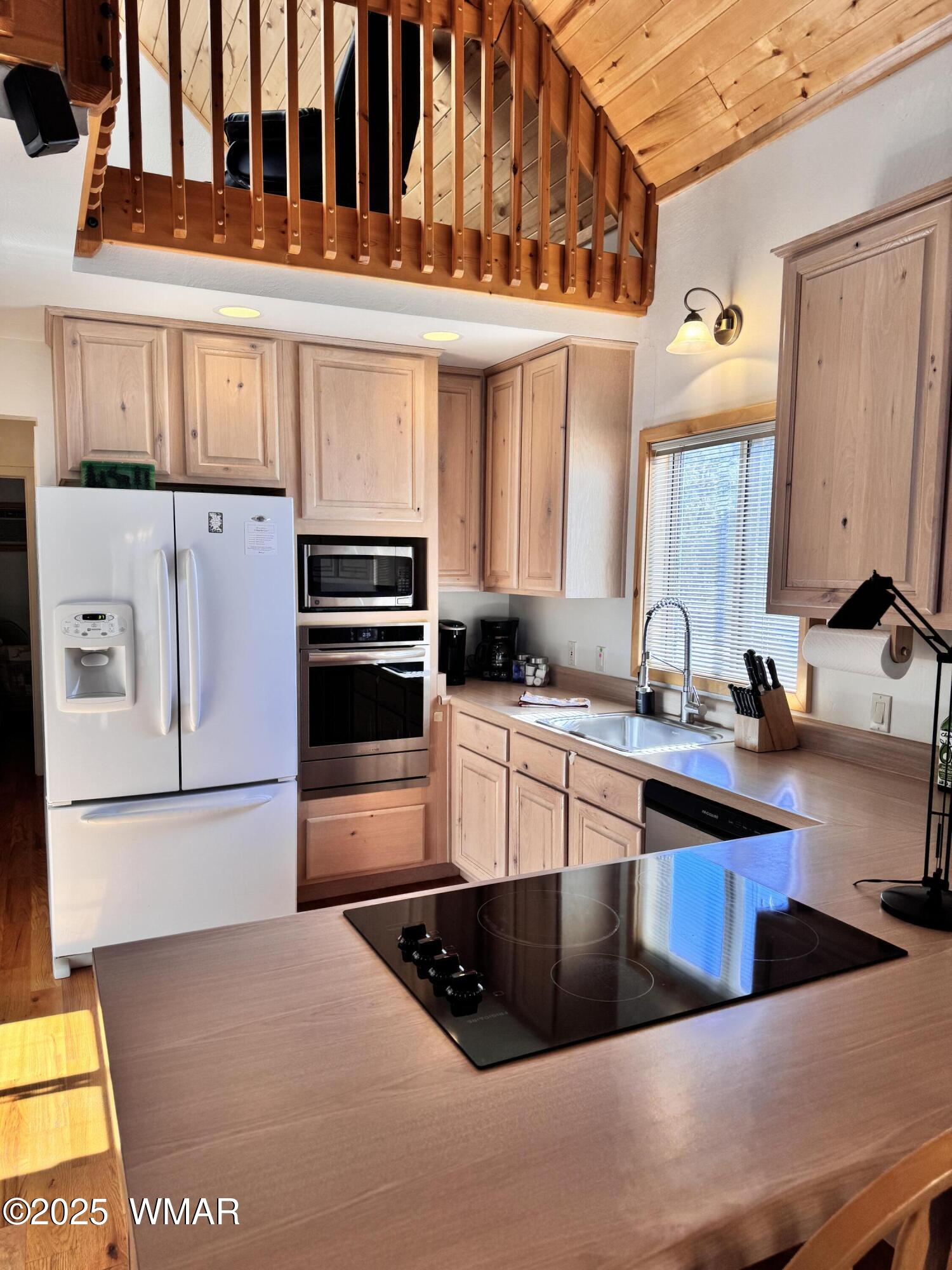 2975 Homestead Drive Overgaard, AZ 85933 - Photo 11 of 12 a kitchen with stainless steel appliances granite countertop a refrigerator and a stove