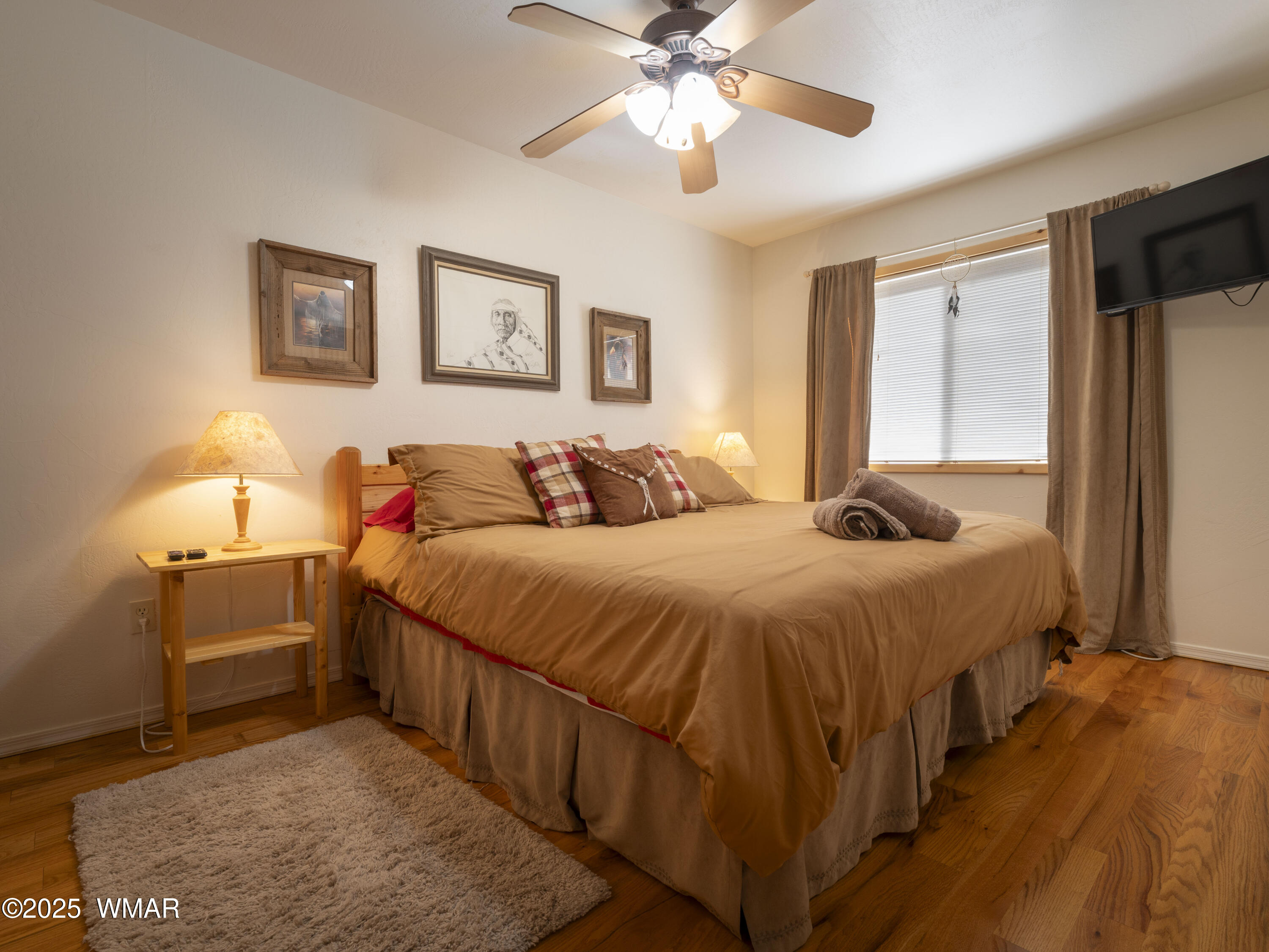 2975 Homestead Drive Overgaard, AZ 85933 - Photo 6 of 12 a bedroom with a bed and a chandelier