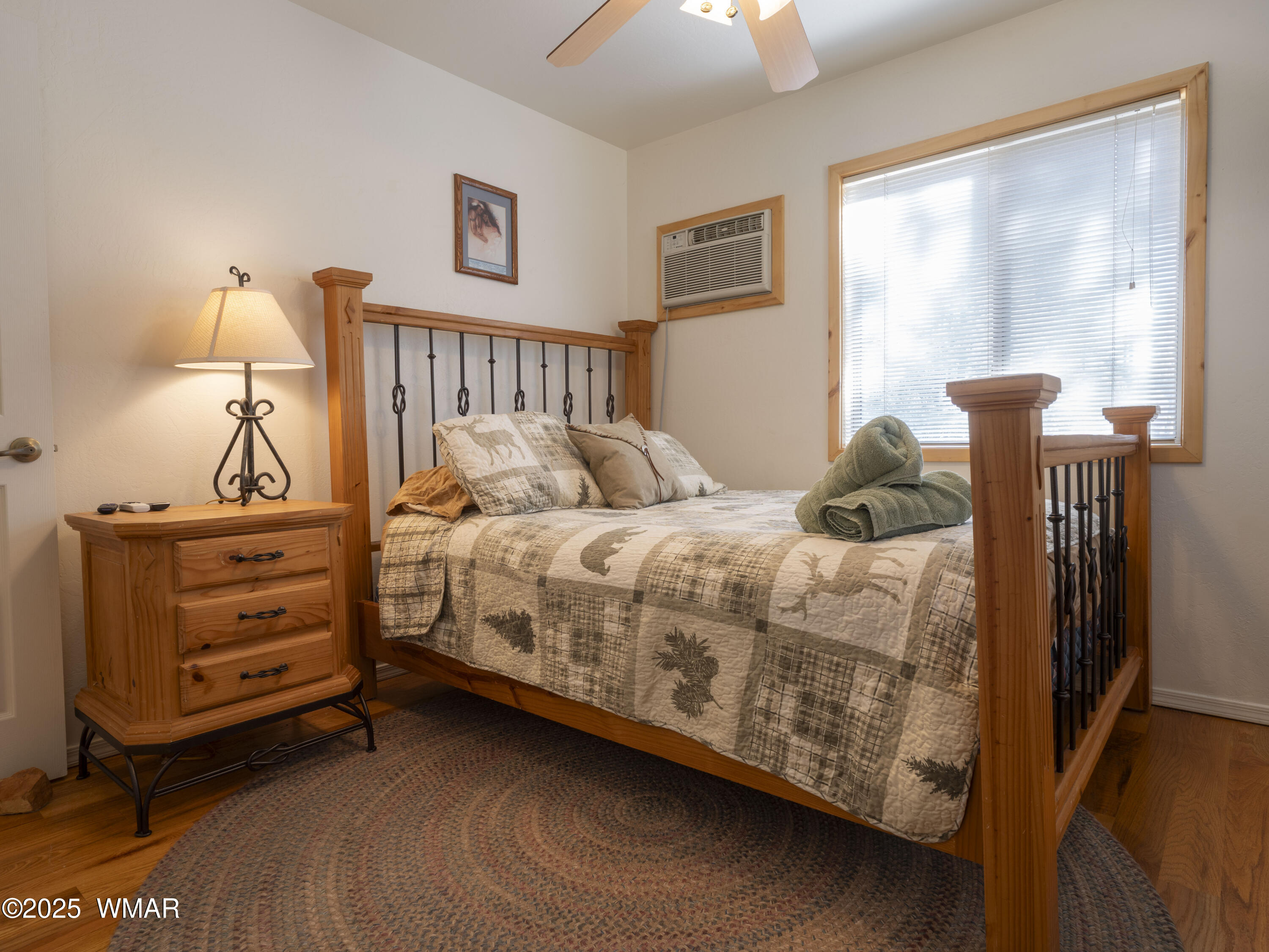 2975 Homestead Drive Overgaard, AZ 85933 - Photo 7 of 12 a bedroom with a bed and a window
