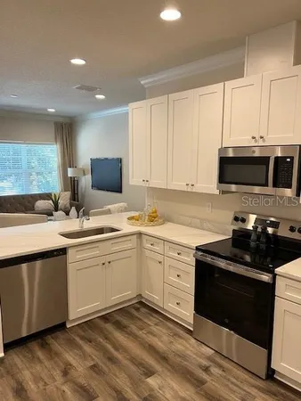 a kitchen with sink cabinets and appliances