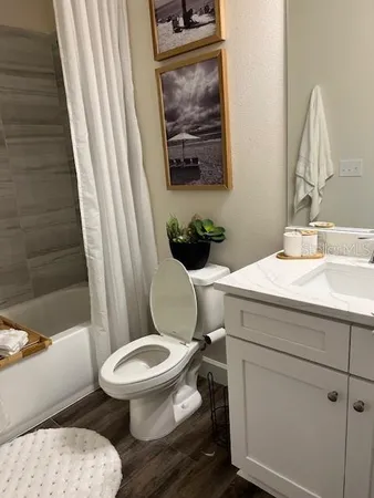 a white toilet sitting next to a bathroom sink
