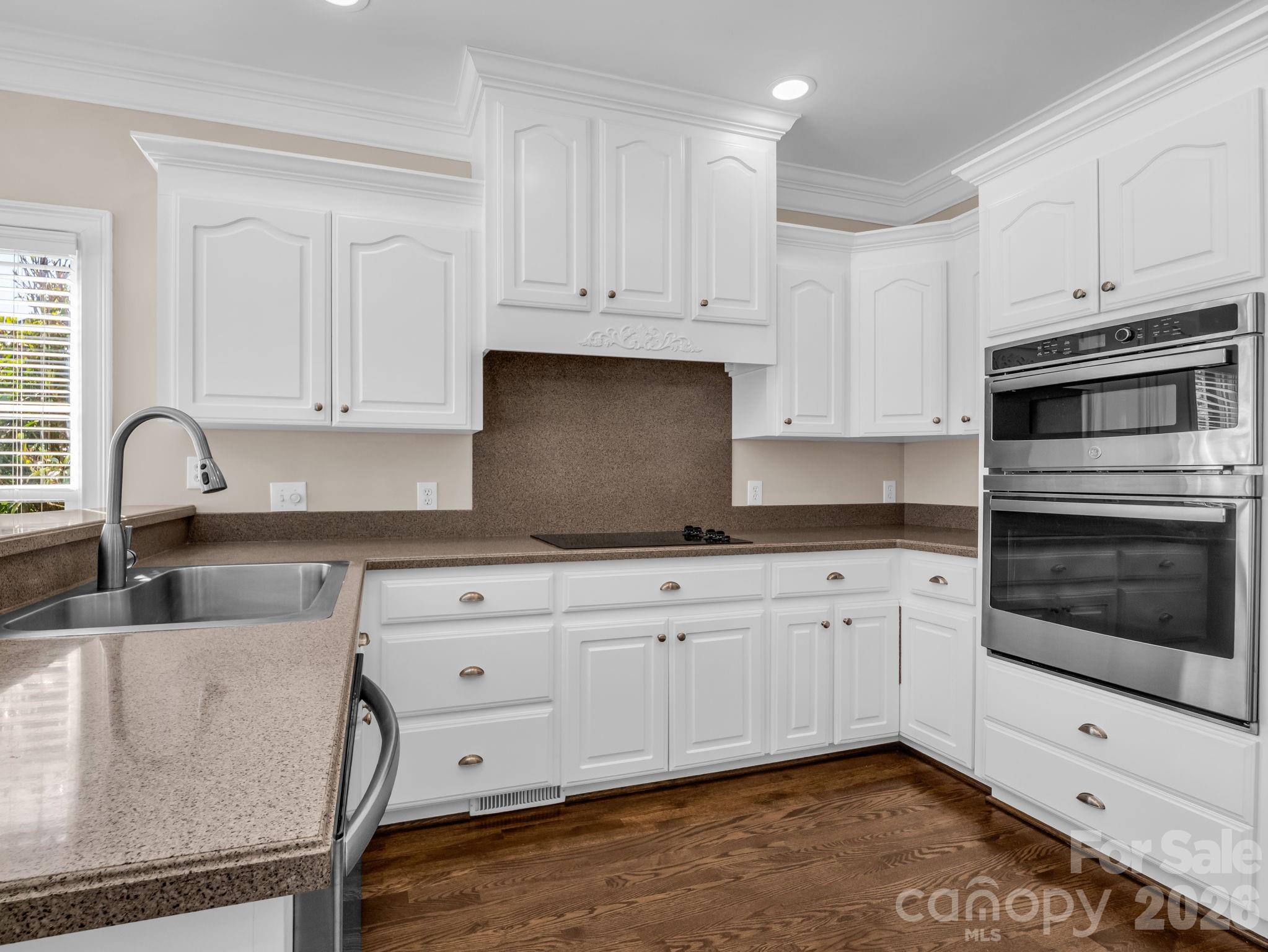 139 North Woodfin Ridge Drive Inman, SC 29349 - Photo 11 of 48 a kitchen with granite countertop white cabinets and stainless steel appliances