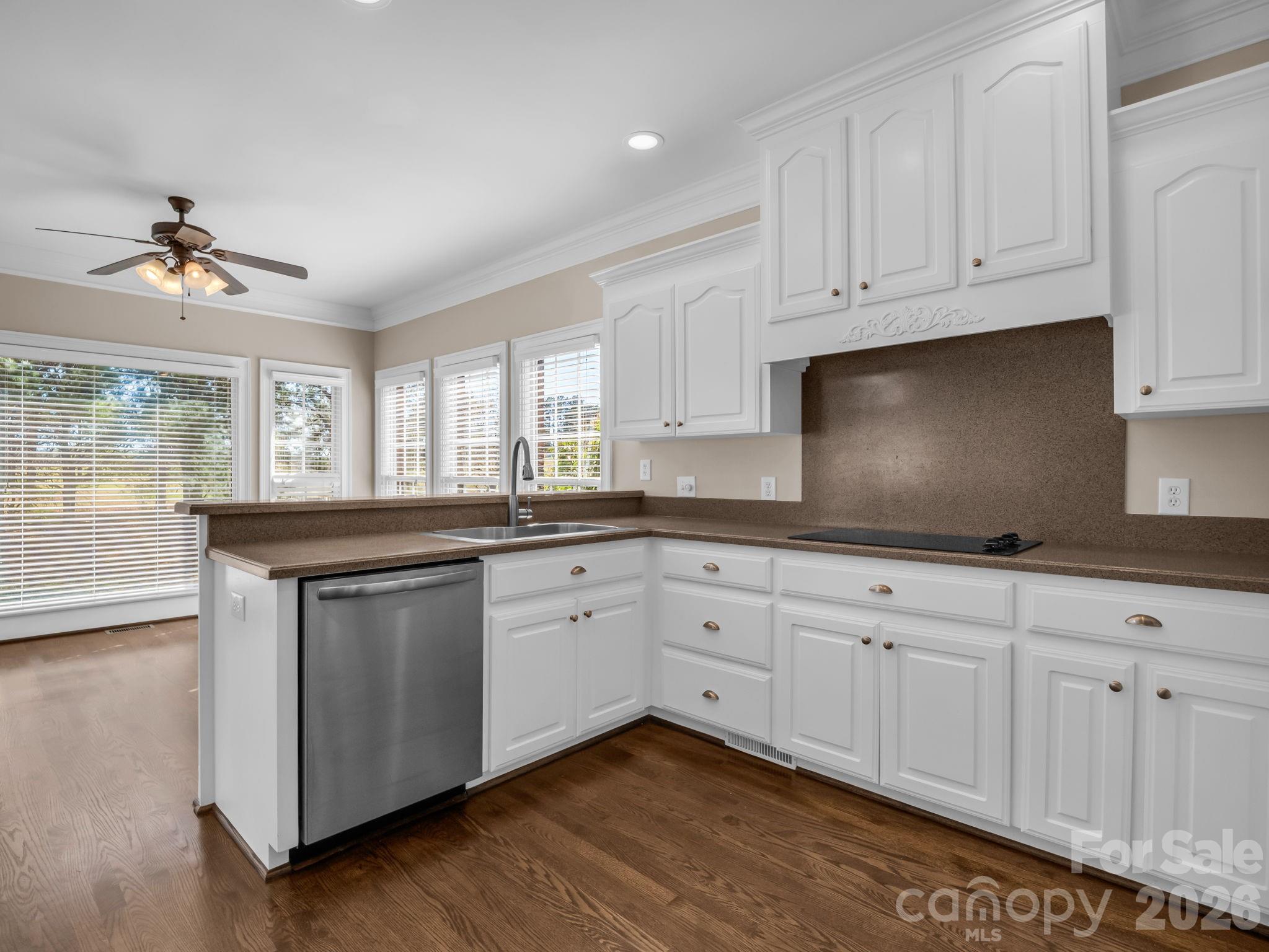 139 North Woodfin Ridge Drive Inman, SC 29349 - Photo 13 of 48 a kitchen with granite countertop white cabinets white appliances a sink and a window