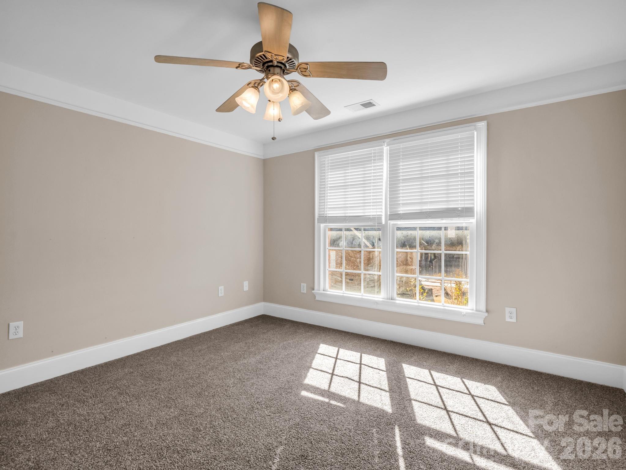 139 North Woodfin Ridge Drive Inman, SC 29349 - Photo 27 of 48 an empty room with windows and chandelier fan