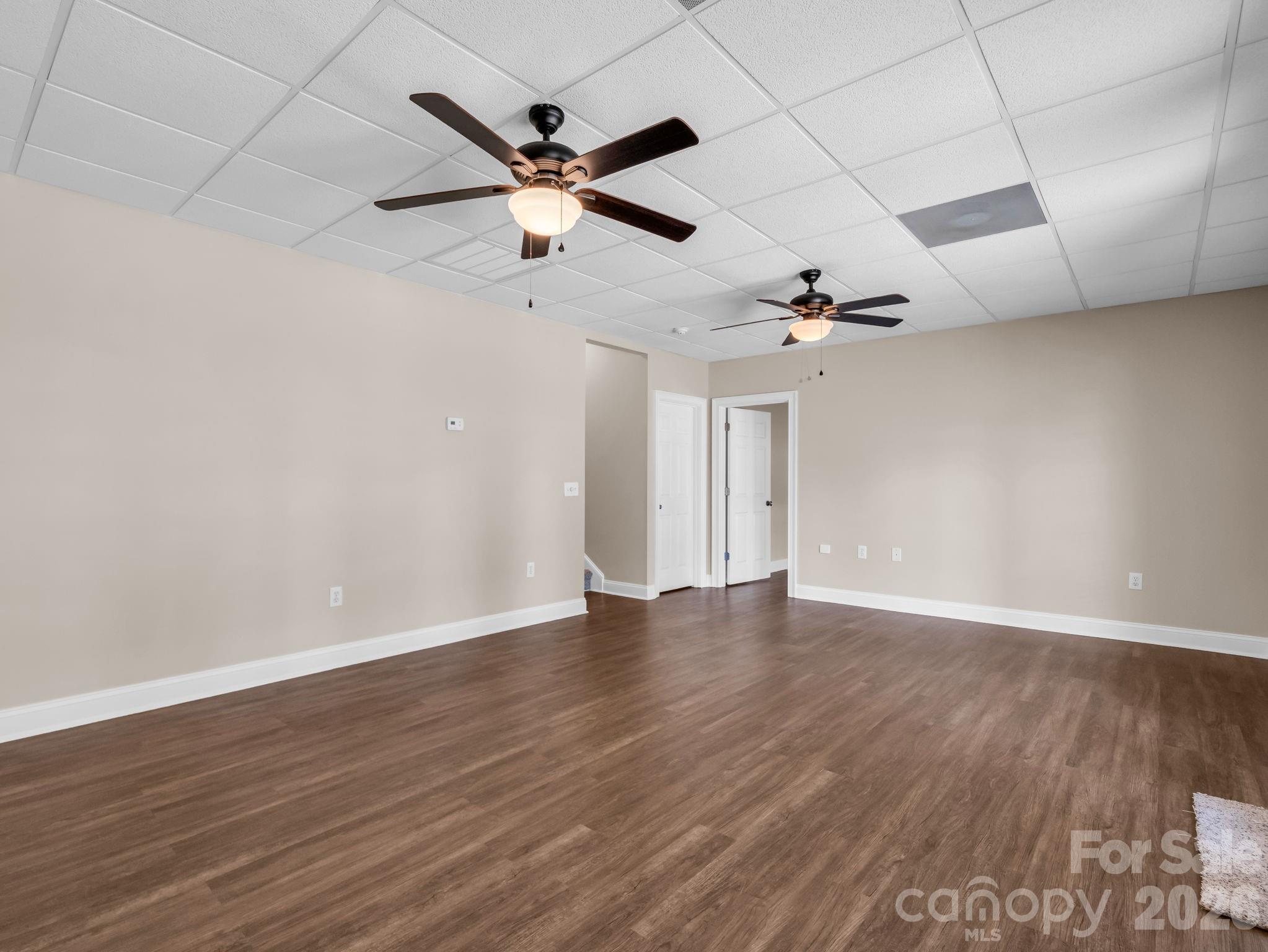 139 North Woodfin Ridge Drive Inman, SC 29349 - Photo 32 of 48 a view of an empty room with wooden floor and a ceiling fan