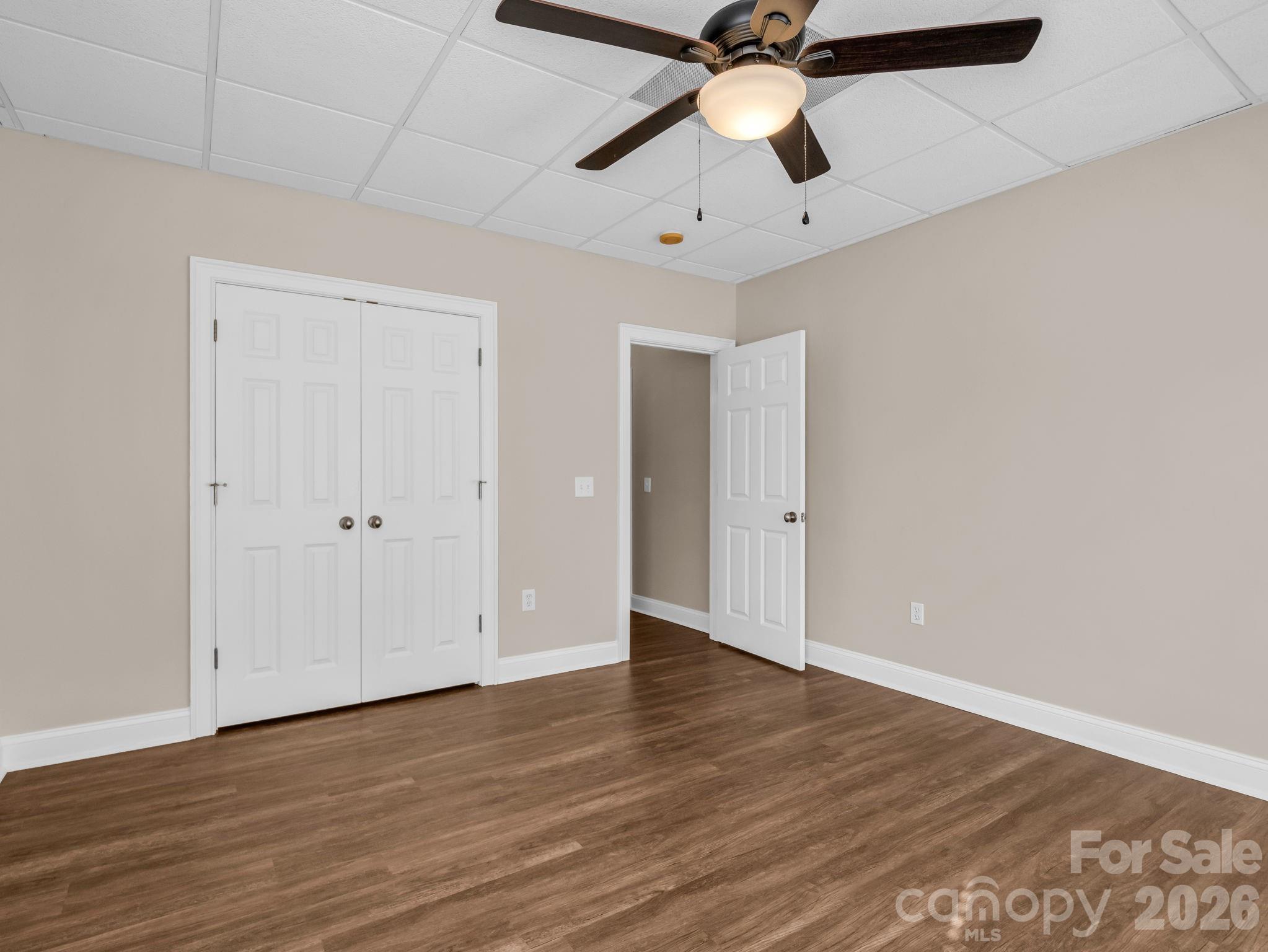 139 North Woodfin Ridge Drive Inman, SC 29349 - Photo 37 of 48 an empty room with wooden floor ceiling fan and windows