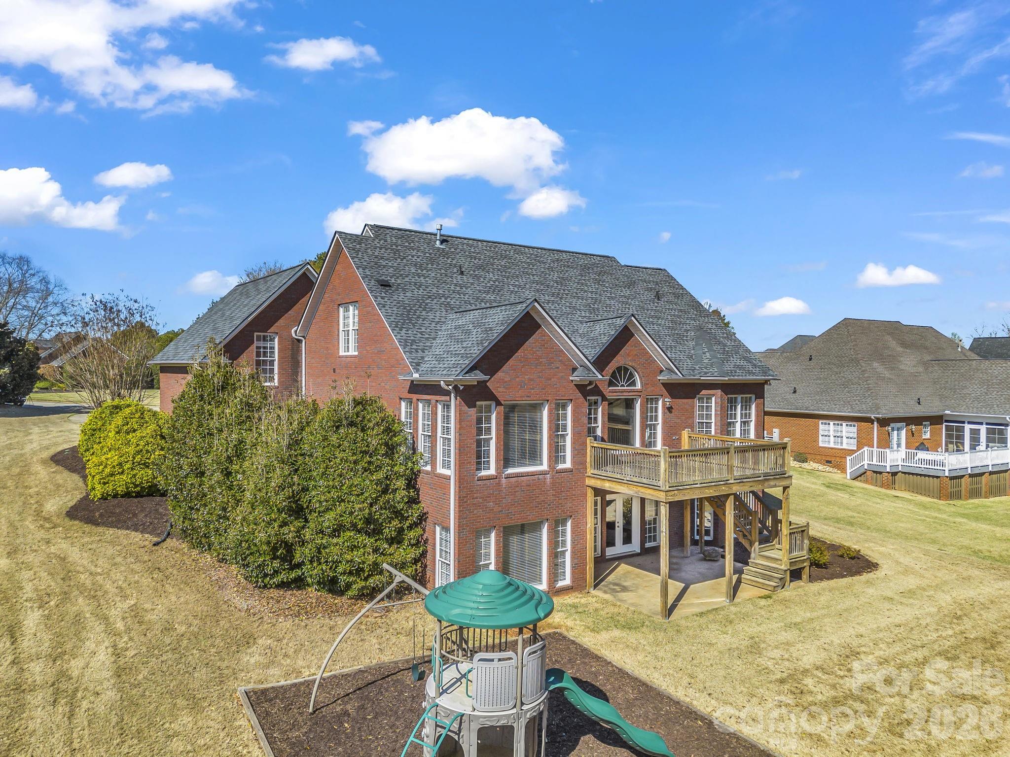139 North Woodfin Ridge Drive Inman, SC 29349 - Photo 45 of 48 a view of a white house with a swimming pool and sitting area