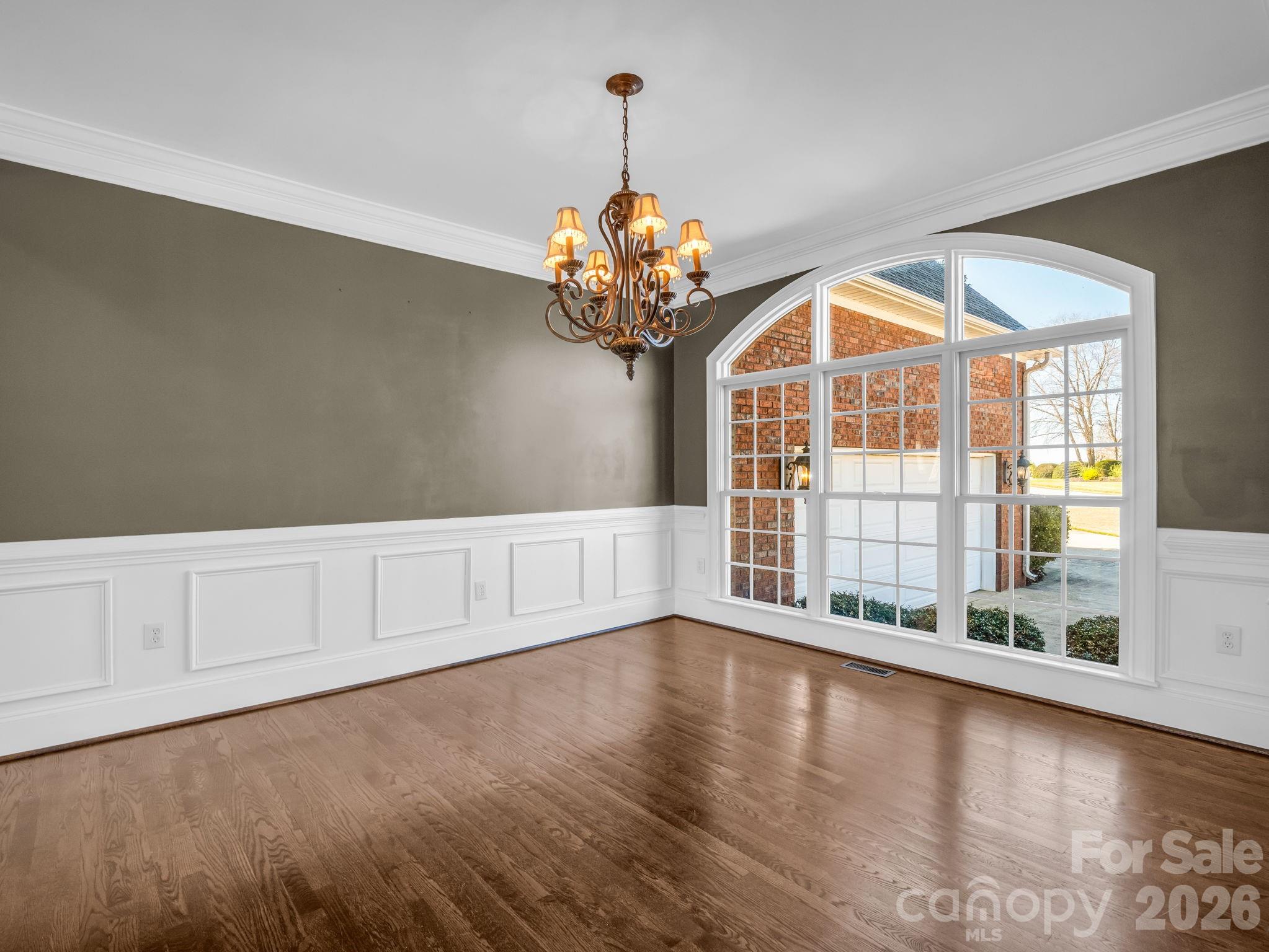 139 North Woodfin Ridge Drive Inman, SC 29349 - Photo 8 of 48 a view of an empty room with chandelier fan and wooden floor