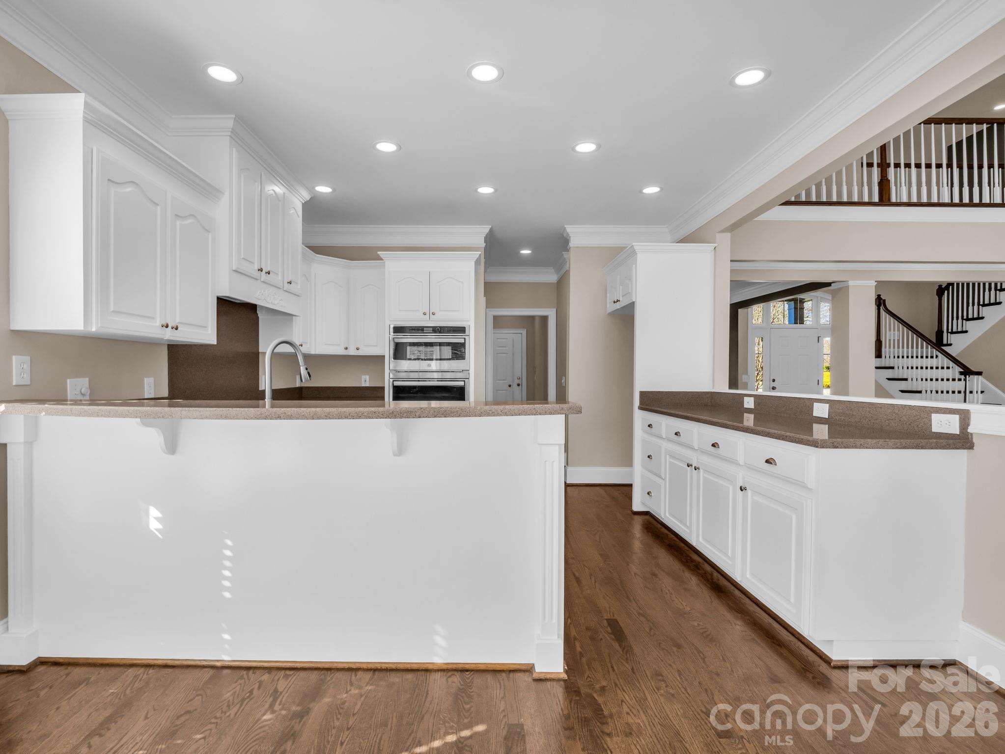 139 North Woodfin Ridge Drive Inman, SC 29349 - Photo 10 of 48 a large white kitchen with stainless steel appliances granite countertop a stove a sink a refrigerator and white cabinets