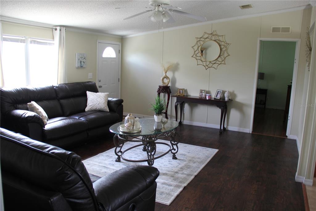13127 Star Road Brooksville, FL 34613 - Photo 6 of 54 a living room with furniture and wooden floor