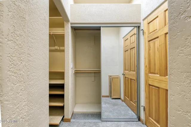 a view of walk in closet with empty room
