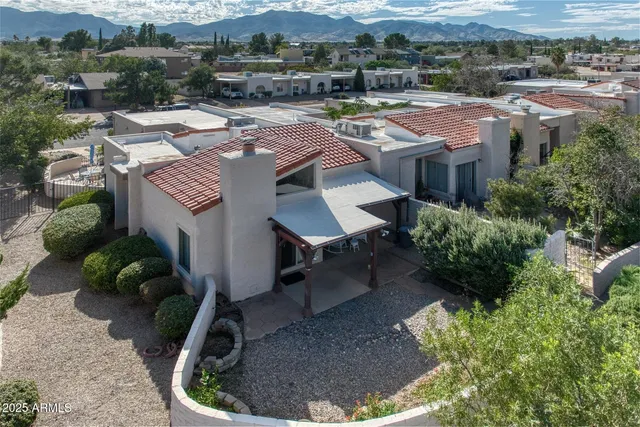 an aerial view of a house with yard and parking space