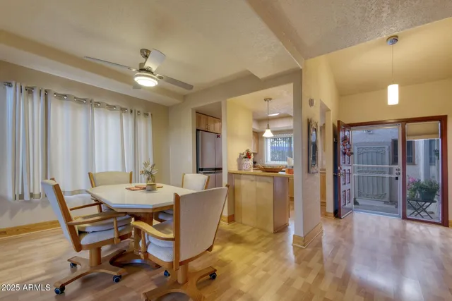 a view of a dining room with furniture and a chandelier