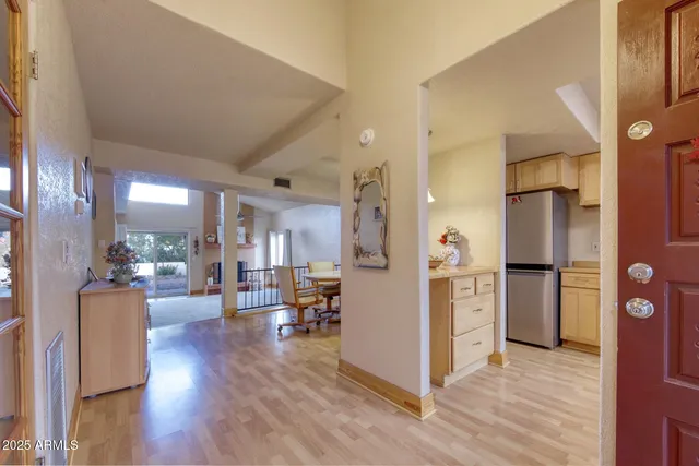 a view of a living room kitchen with furniture and wooden floor