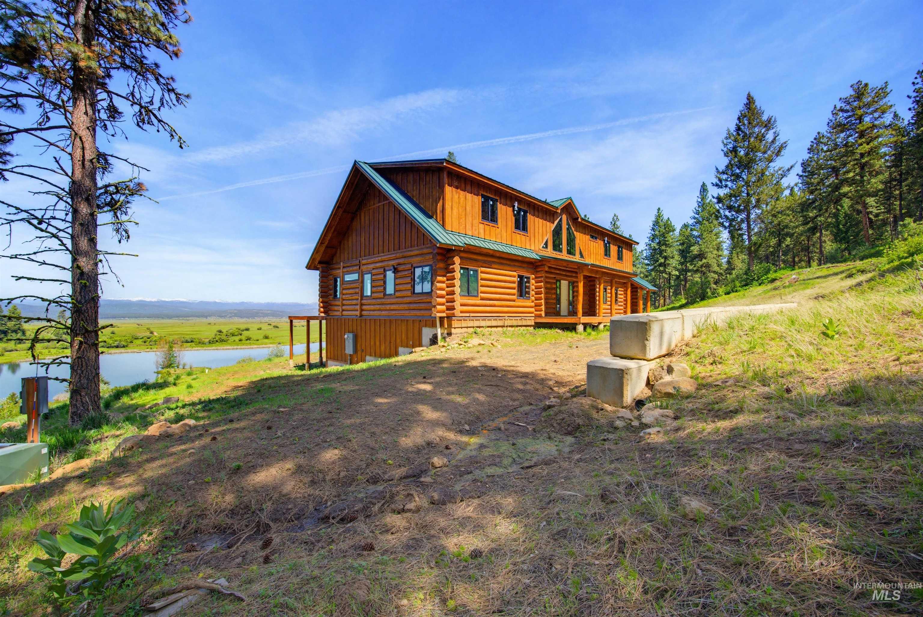 3322 Big Creek Road New Meadows, ID 83654 - Photo 10 of 50 Log-style residence with a green metal roof and a prominent gable