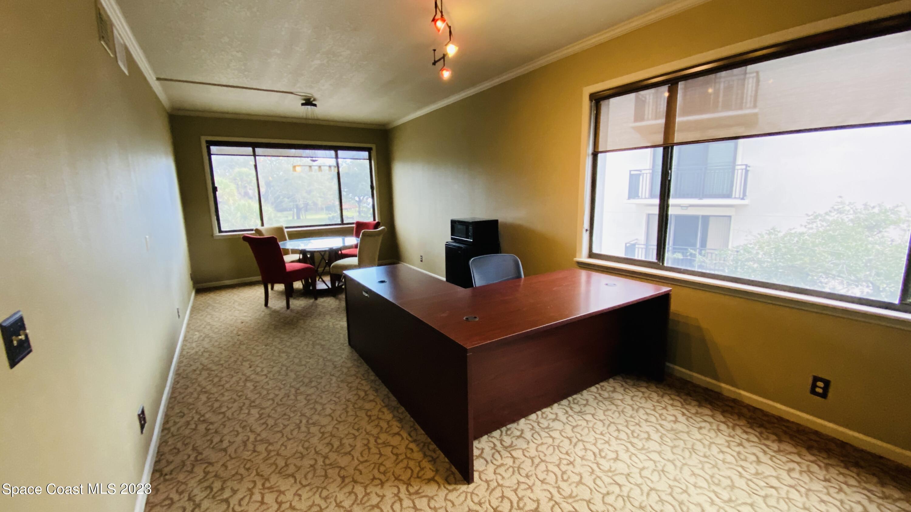 2210 Front Street, Unit 202 Melbourne, FL 32901 - Photo 1 of 2 a living room with dining table furniture and a window