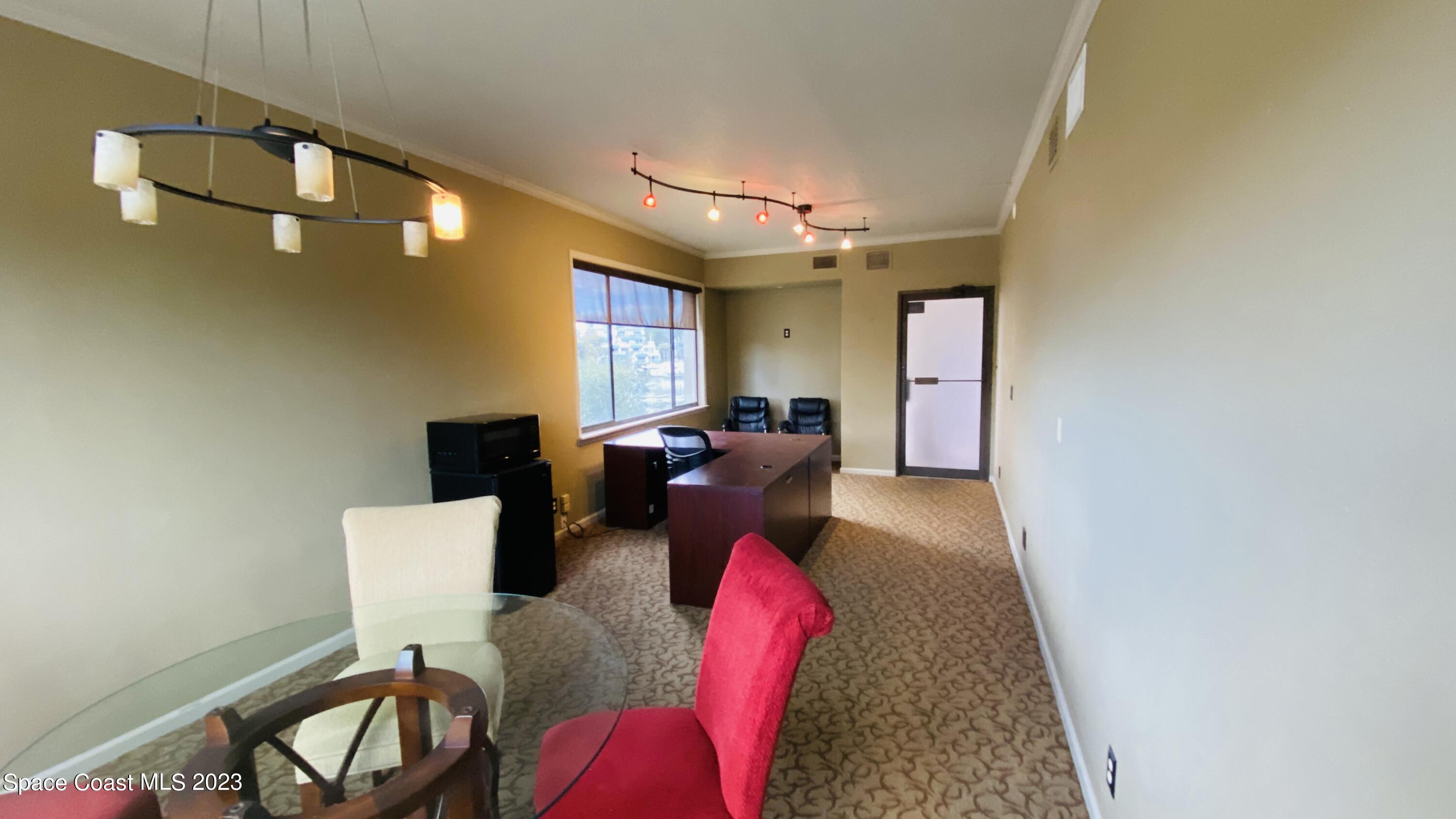 2210 Front Street, Unit 202 Melbourne, FL 32901 - Photo 2 of 2 a living room with furniture and a mirror
