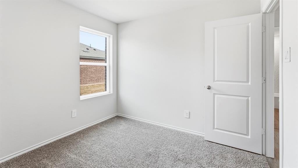 3319 Twilight Trail Forney, TX 75126 - Photo 29 of 33 Neutral-toned room featuring light gray walls, plush gray carpeting, and white baseboards