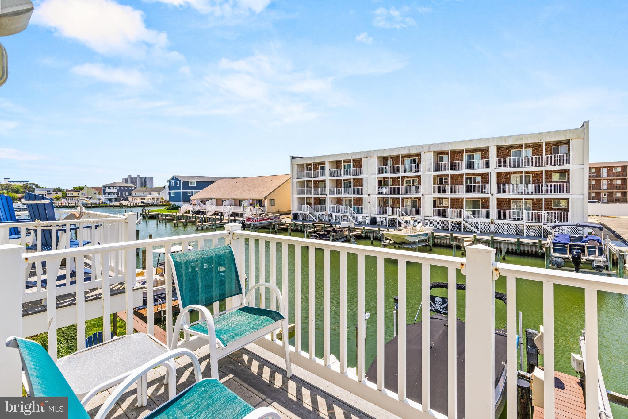 617 Salt Spray Road, Unit B Ocean City, MD 21842 - Photo 40 of 72 a view of a chairs and table in a balcony