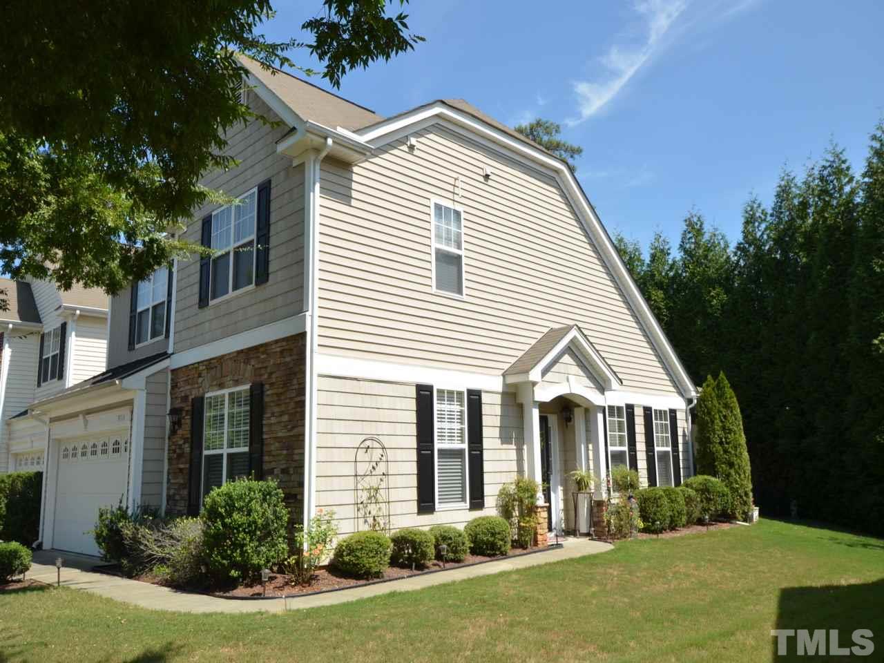 9714 Renfield Drive Raleigh, NC 27617 - Photo 2 of 25 a view of a white house next to a yard with plants and trees
