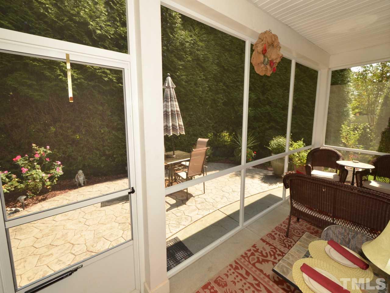 9714 Renfield Drive Raleigh, NC 27617 - Photo 17 of 25 a view of living room with a floor to ceiling window and wooden floor