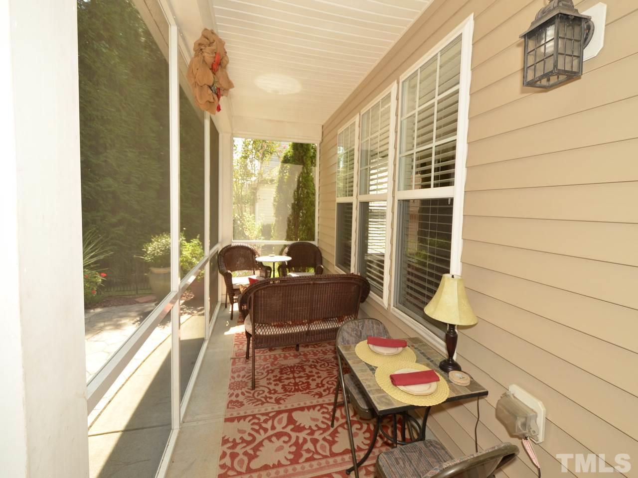 9714 Renfield Drive Raleigh, NC 27617 - Photo 18 of 25 a balcony with furniture and wooden floor