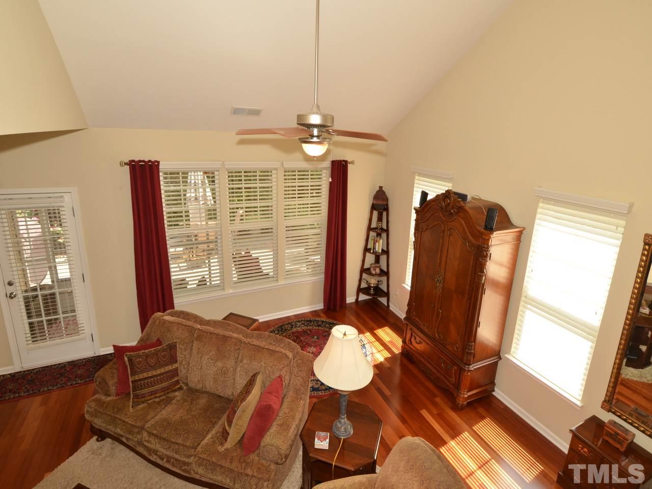 9714 Renfield Drive Raleigh, NC 27617 - Photo 24 of 25 a living room with furniture chandelier and a window