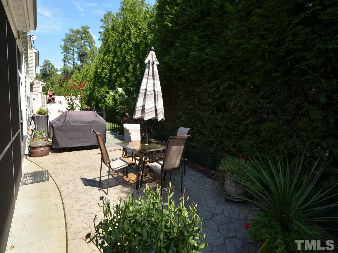 9714 Renfield Drive Raleigh, NC 27617 - Photo 4 of 25 a view of backyard with table and chairs and potted plants